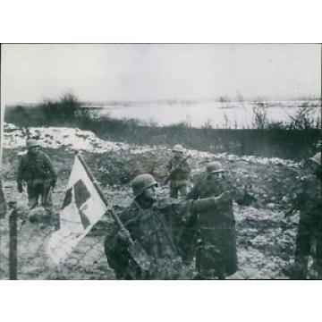 Bearing   a red cross flag on shovel, two German soldiers surrender near Metz and
